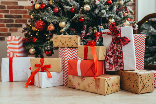Multicolored Gifts Under The Christmas Tree Photo Closeup New Years Eve Multicolored Gifts Red And Gray And Black Stock Photo - Download Image Now - iStock